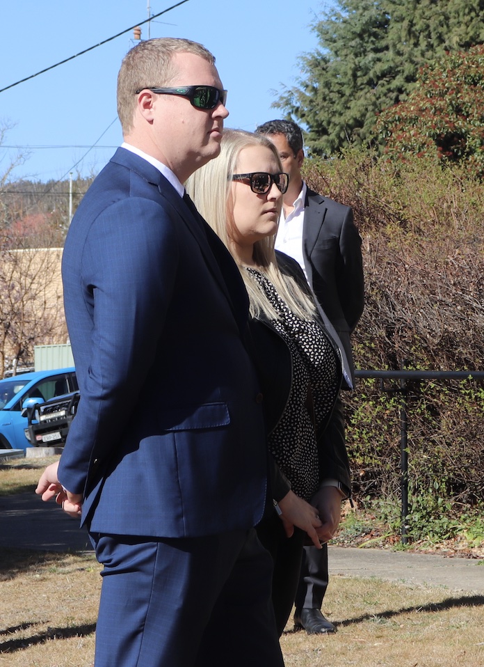 man wearing a suit standing outside