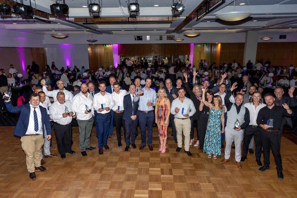 group of people holding awards