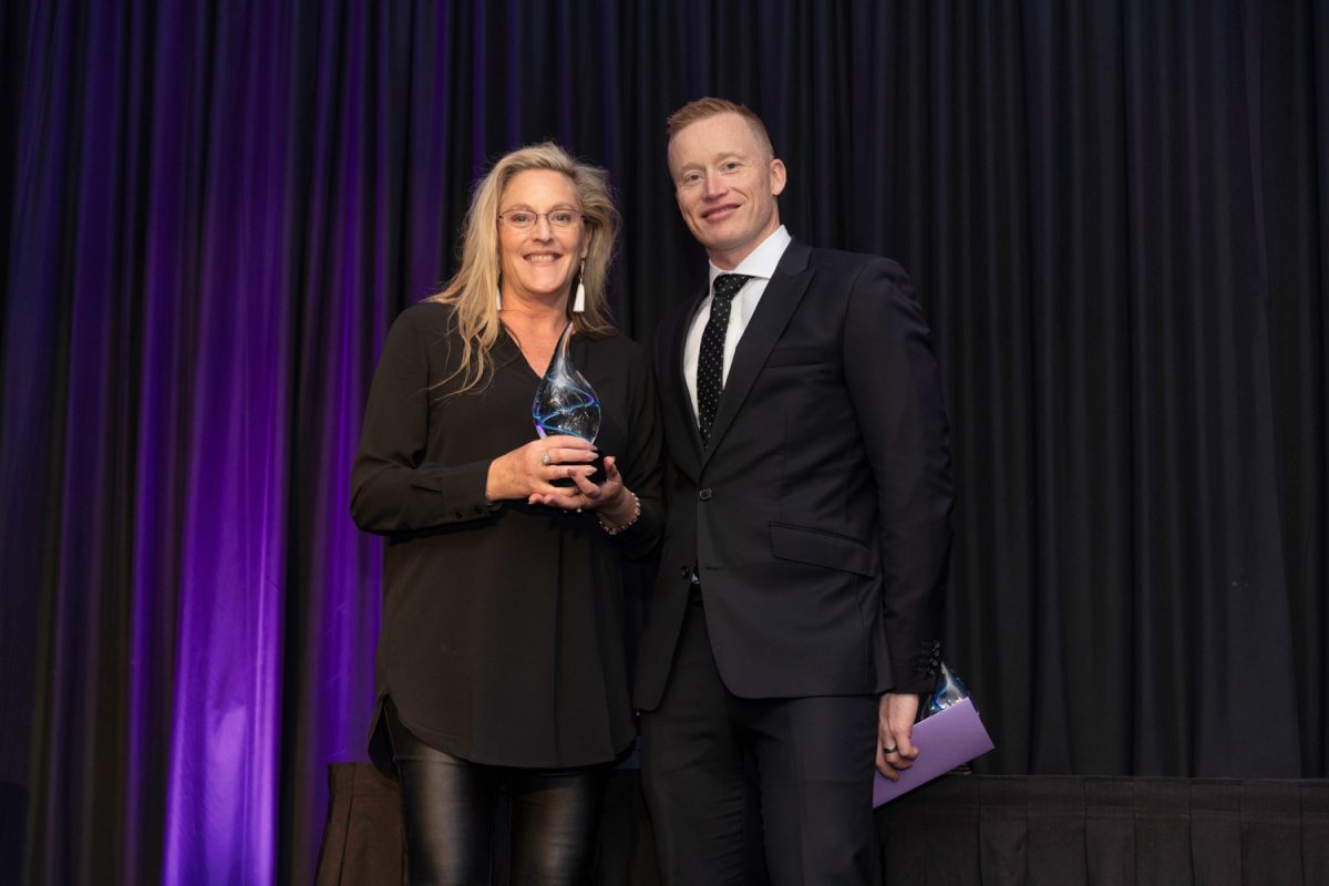 two people holding an award