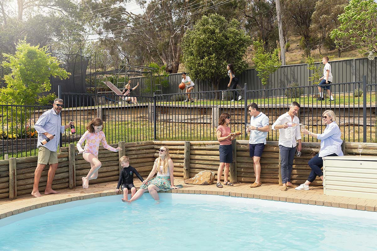 people around a backyard pool