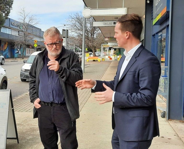 two men talking in street