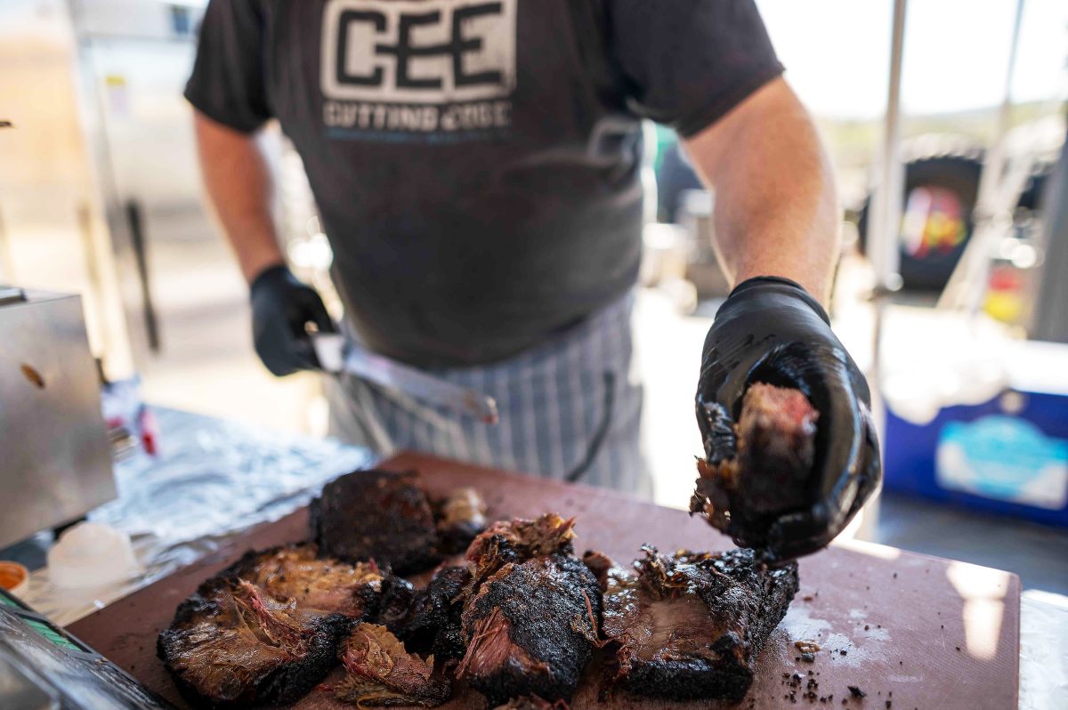 A man chopping up smoked beef.