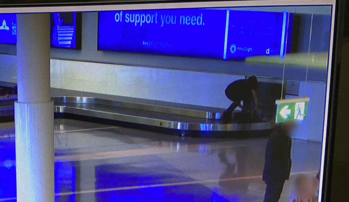 person on airport baggage carousel
