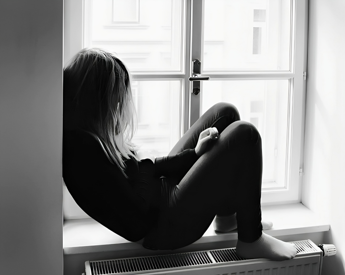 A child sitting next to window