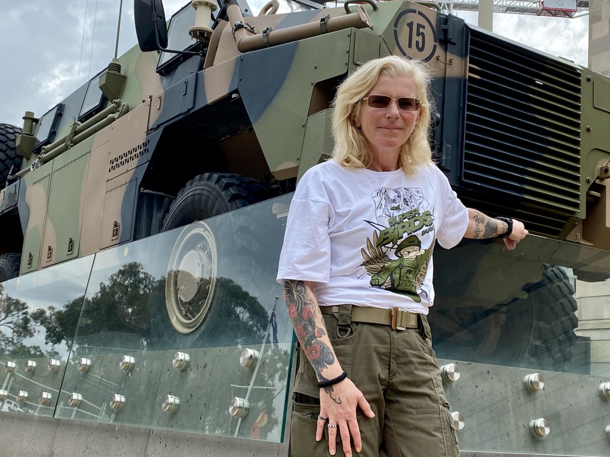 Woman standing in front of Bushmaster tank