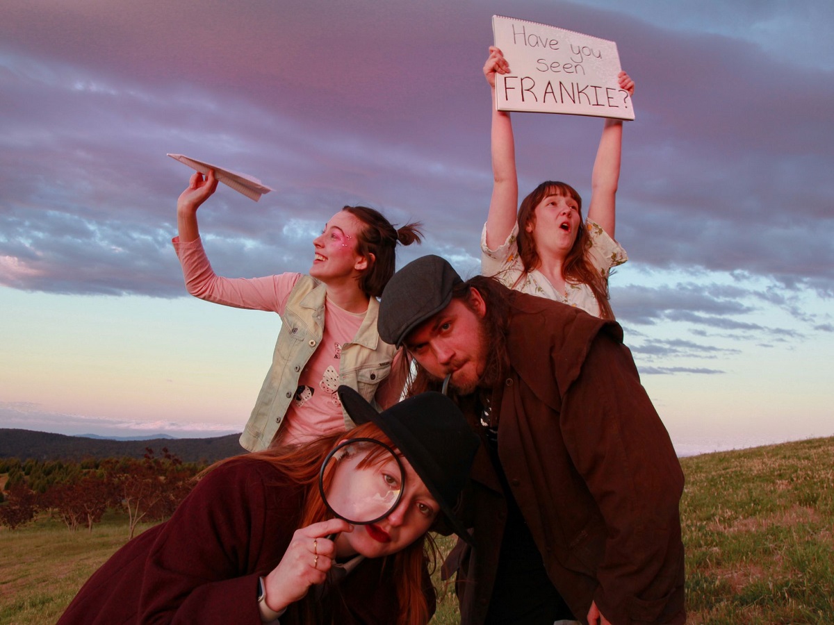 Performers holding up signs or bending over