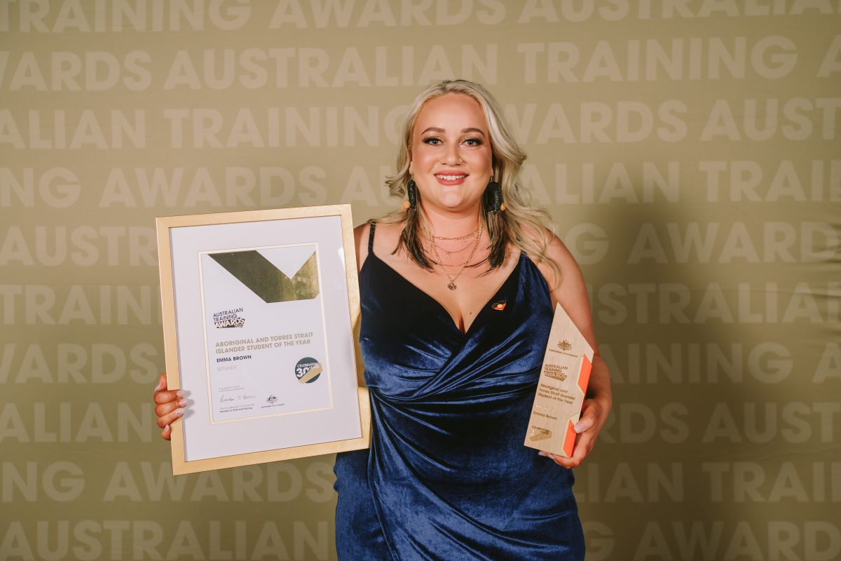 Emma Brown holding certificate and trophy