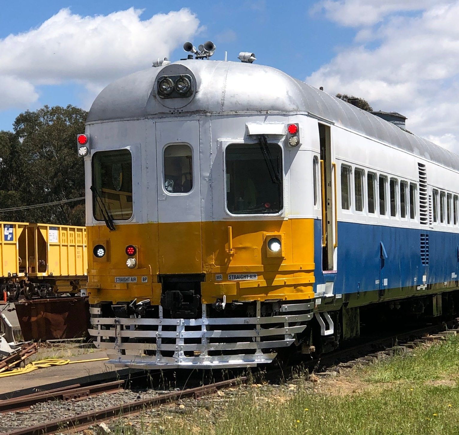 A train painted in blue, white and yellow