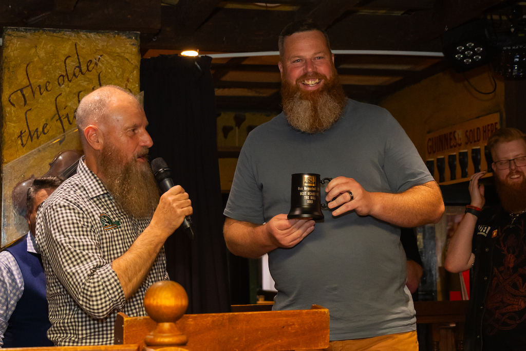 man being awarded a small trophy