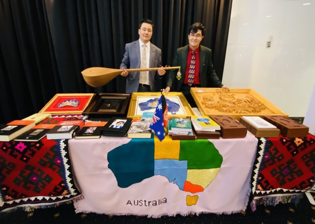 two people behind table display