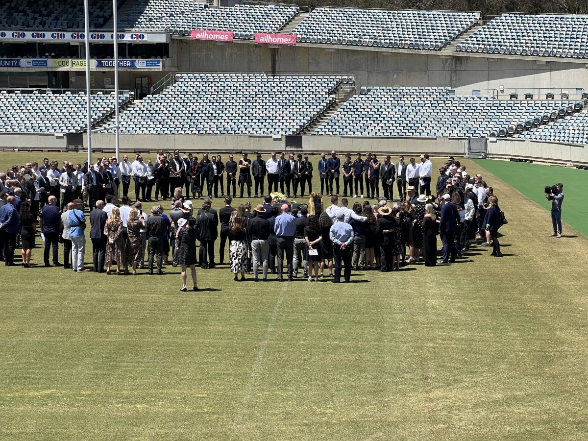 people in a circle at Canberra Stadium