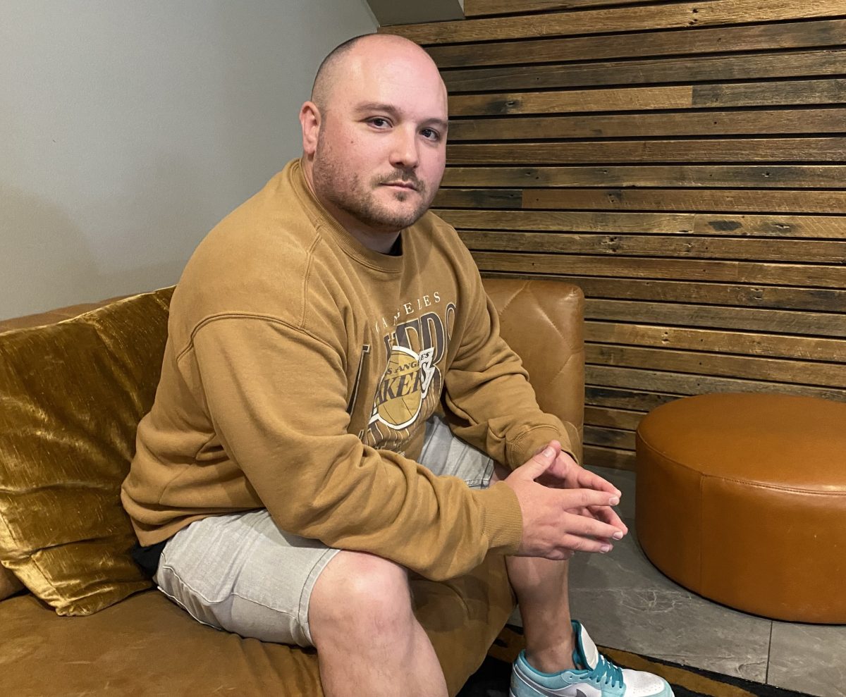 Child sex abuse survivor Josh Byrnes sitting on a lounge