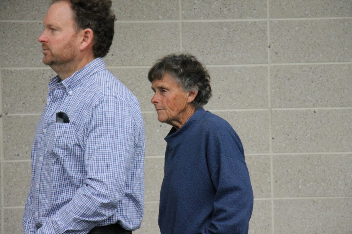 older woman and man outside court