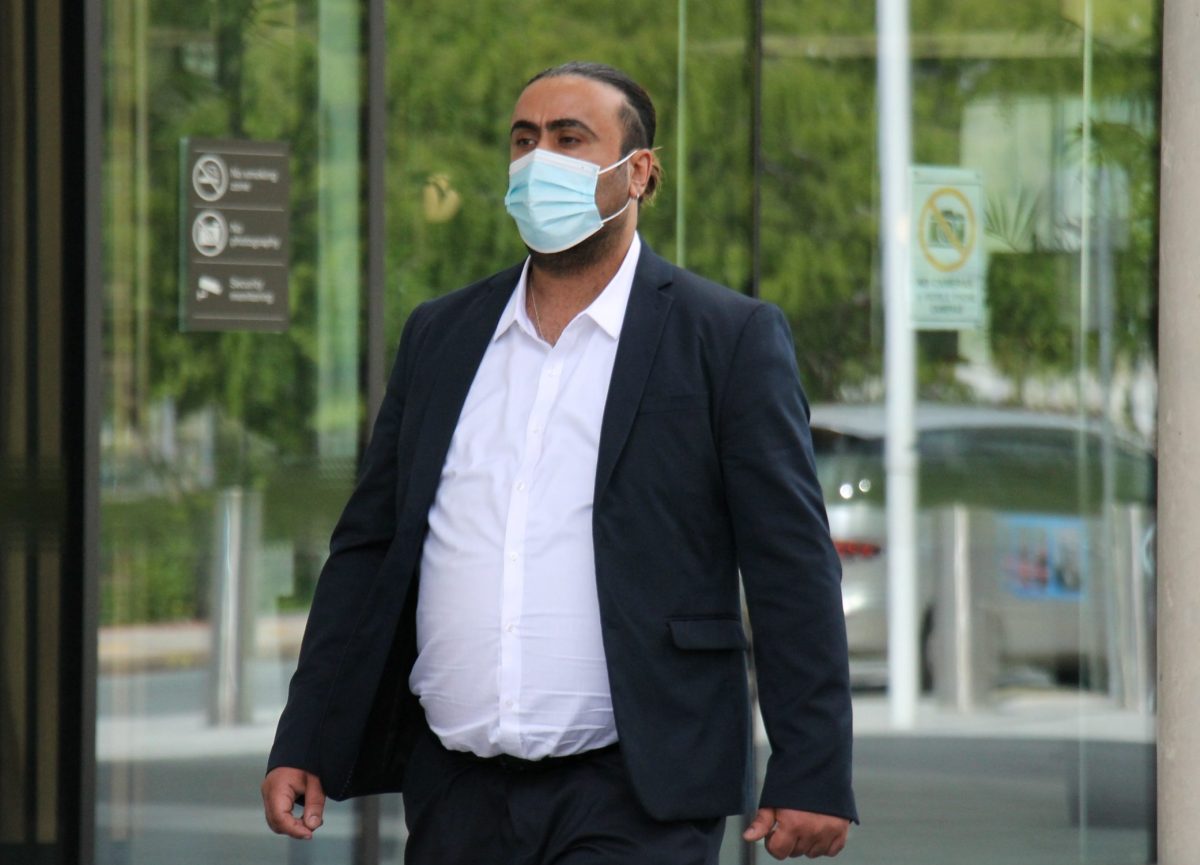 man in mask leaving court