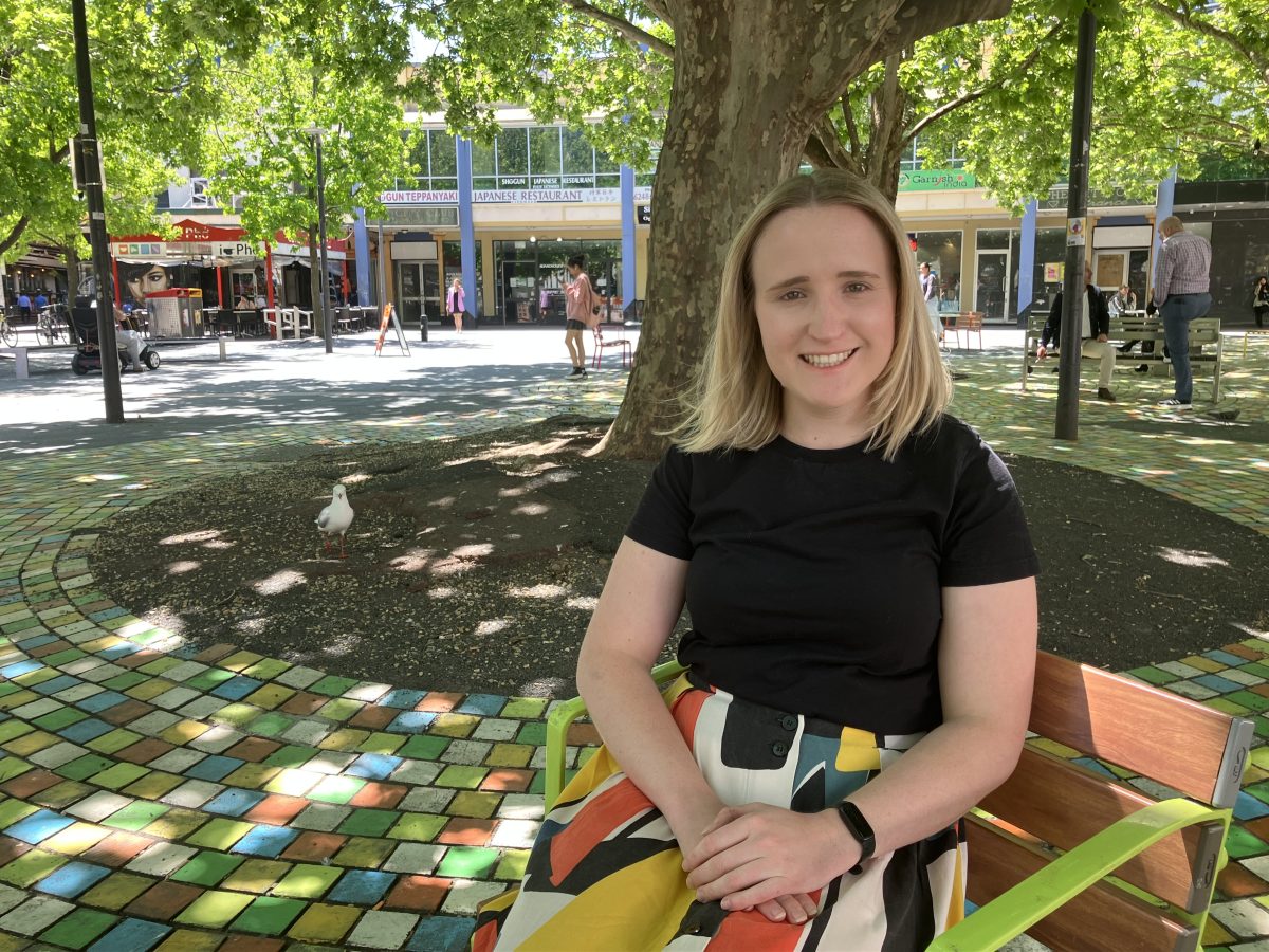 woman sitting on a bench in Garema Place