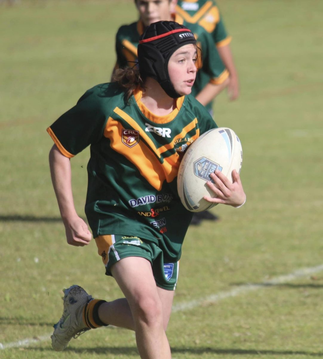 boy playing rugby league