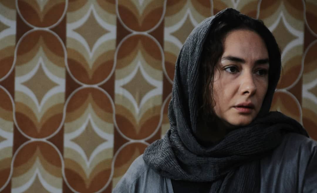 A still from a movie, showing a woman in a hijab
