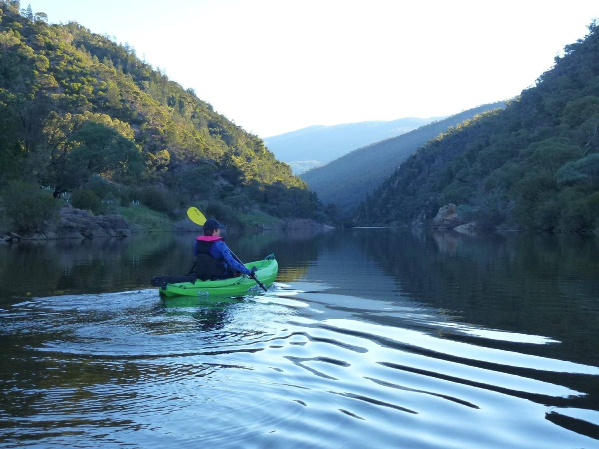 Woman paddling through river