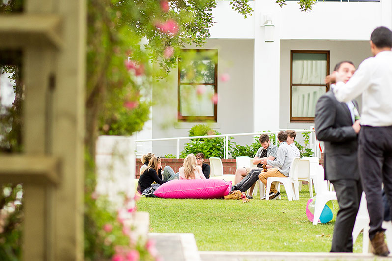 People lounging in courtyard with food and drinks