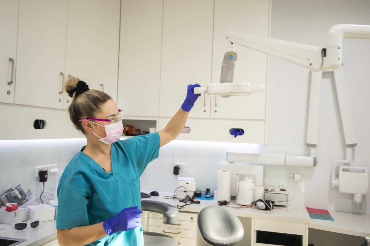 dentist setting up equipment