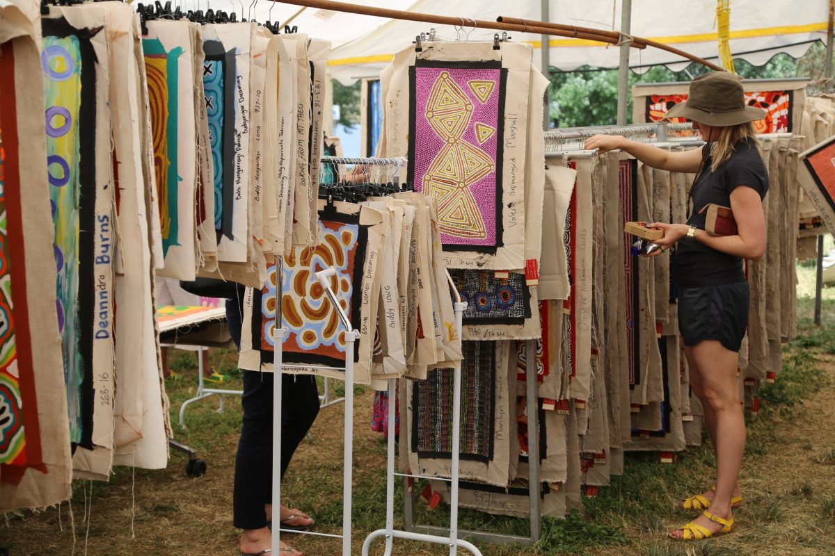 A woman browsing art in a market