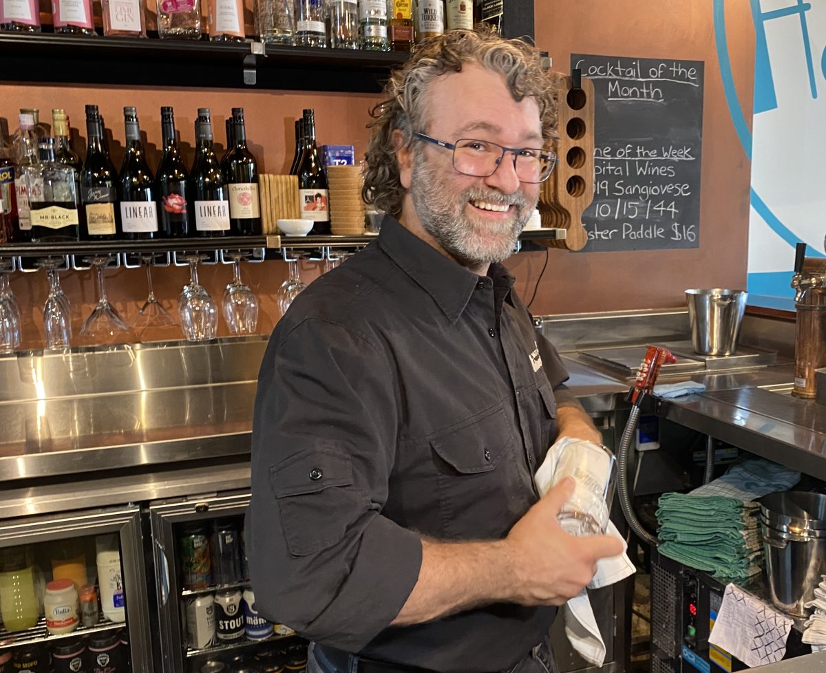 Herbert's co-owner Dino Martiniello polishing a glass