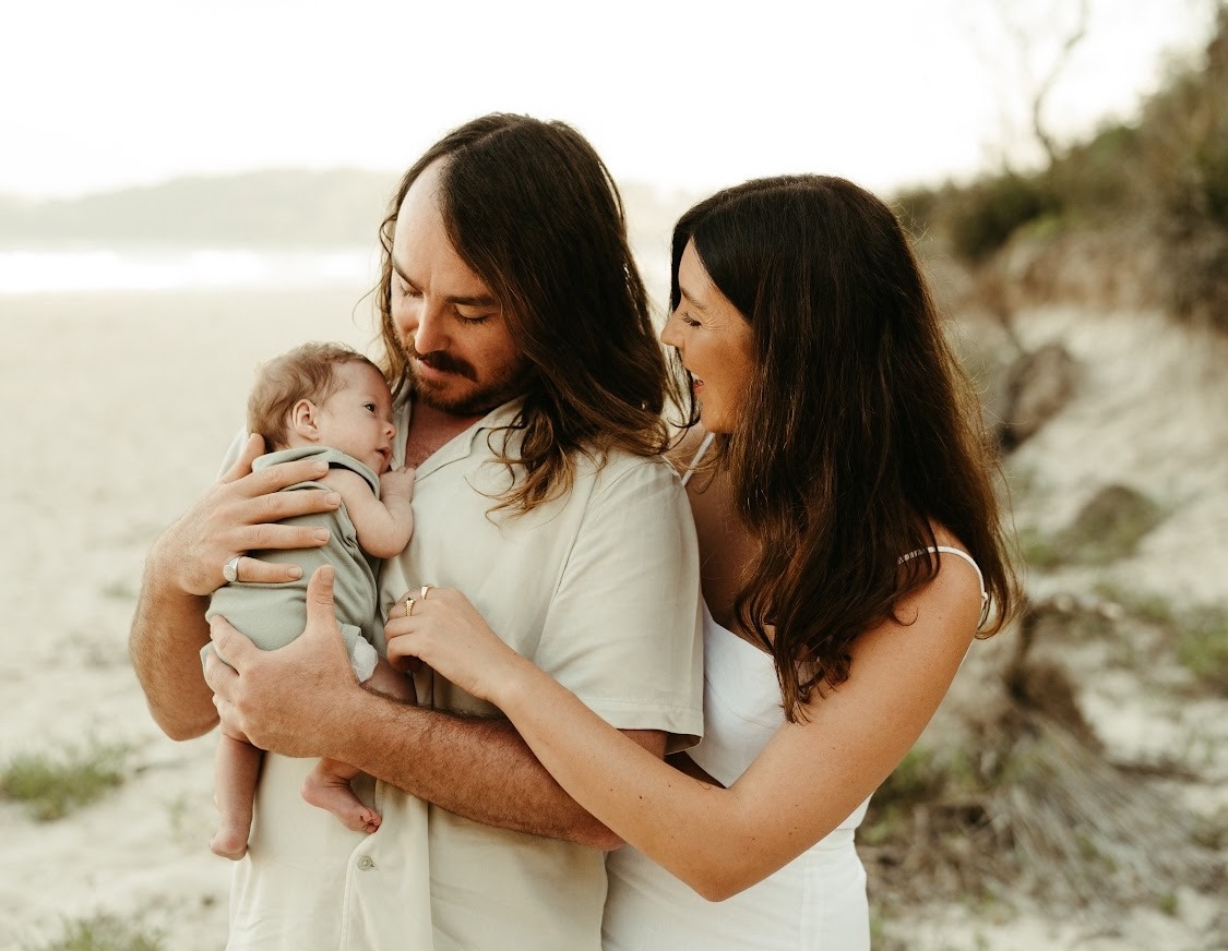 Malua Bay couple Mallory Hazelton and Harley Jagelman with baby Cove at a beach