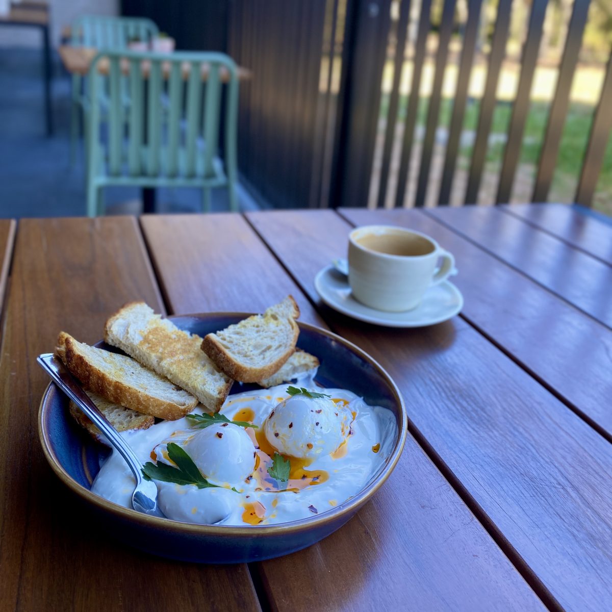 A plate of poached eggs with toast and chilli oil.