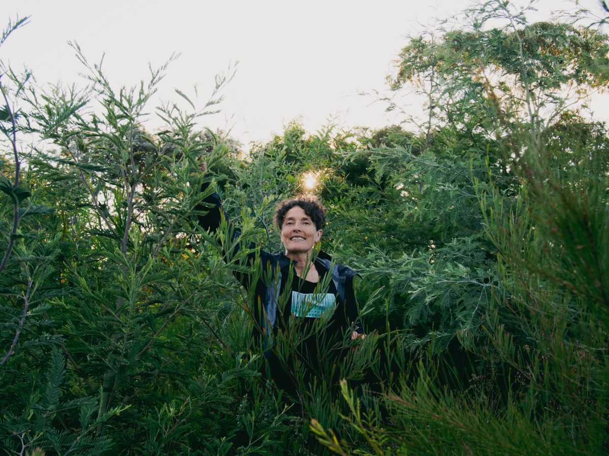 Edwina Mason stands in a tangle of thriving native shrubs and saplings