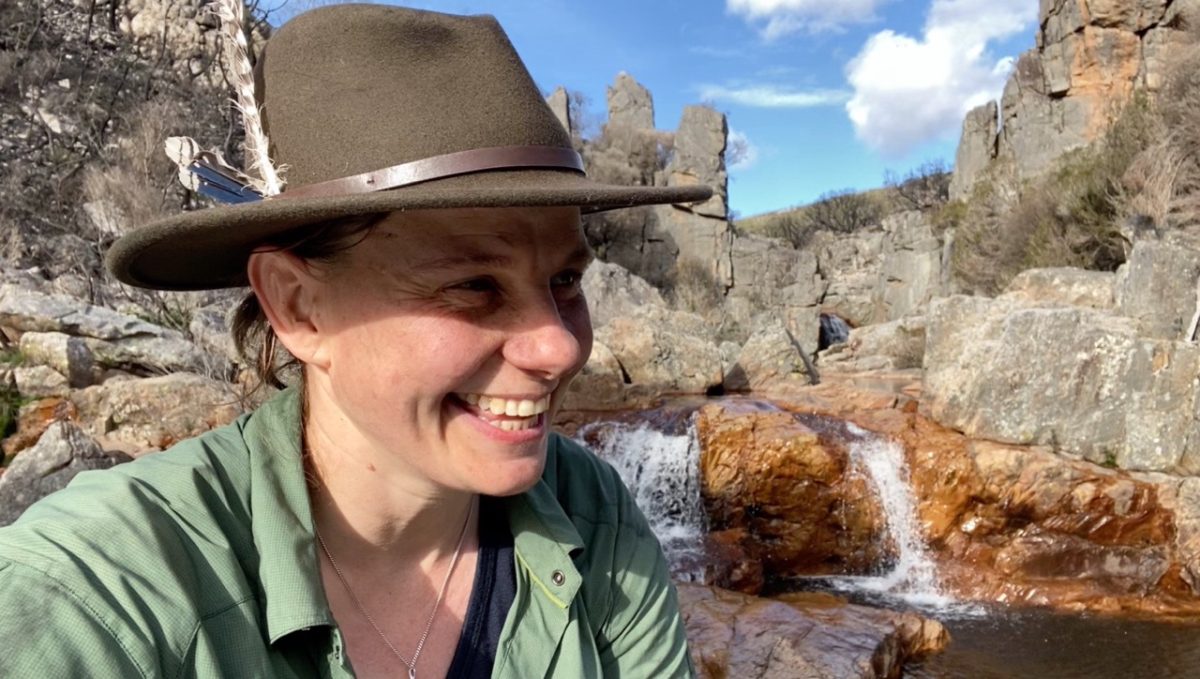 Woman smiling with a hat on