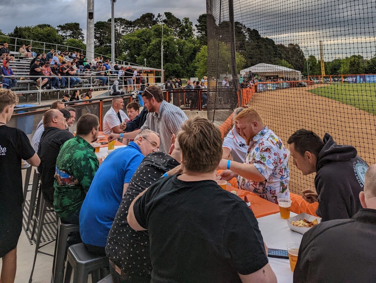 Group of people have beer and food at a Canberra Cavalry baseball game
