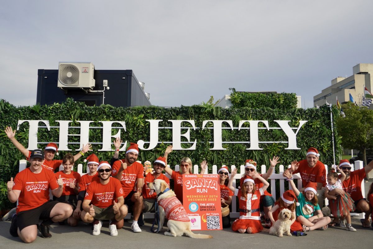 People in Santa hats and red t-shirts at the Jetty in Canberra for Running for Resilience Santa Run