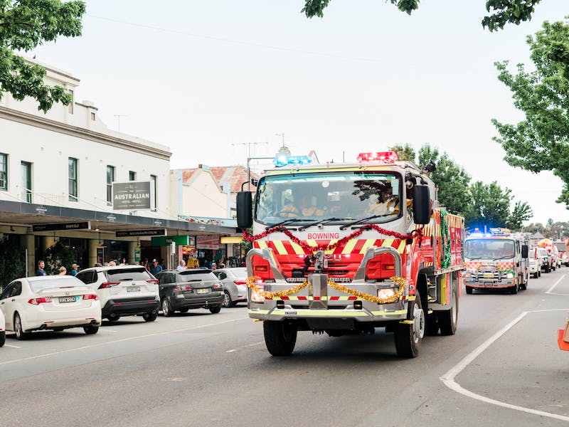 fire truck decorated with tinsel driving in a parade