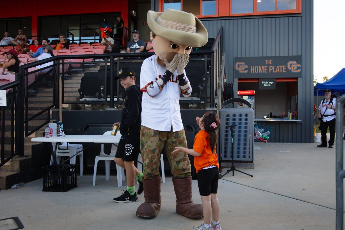 Canberra Cavalry mascot Sarge with a young supporter