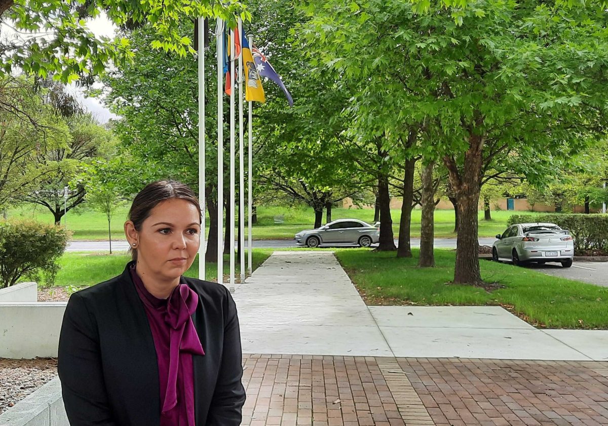 woman standing in street near flags