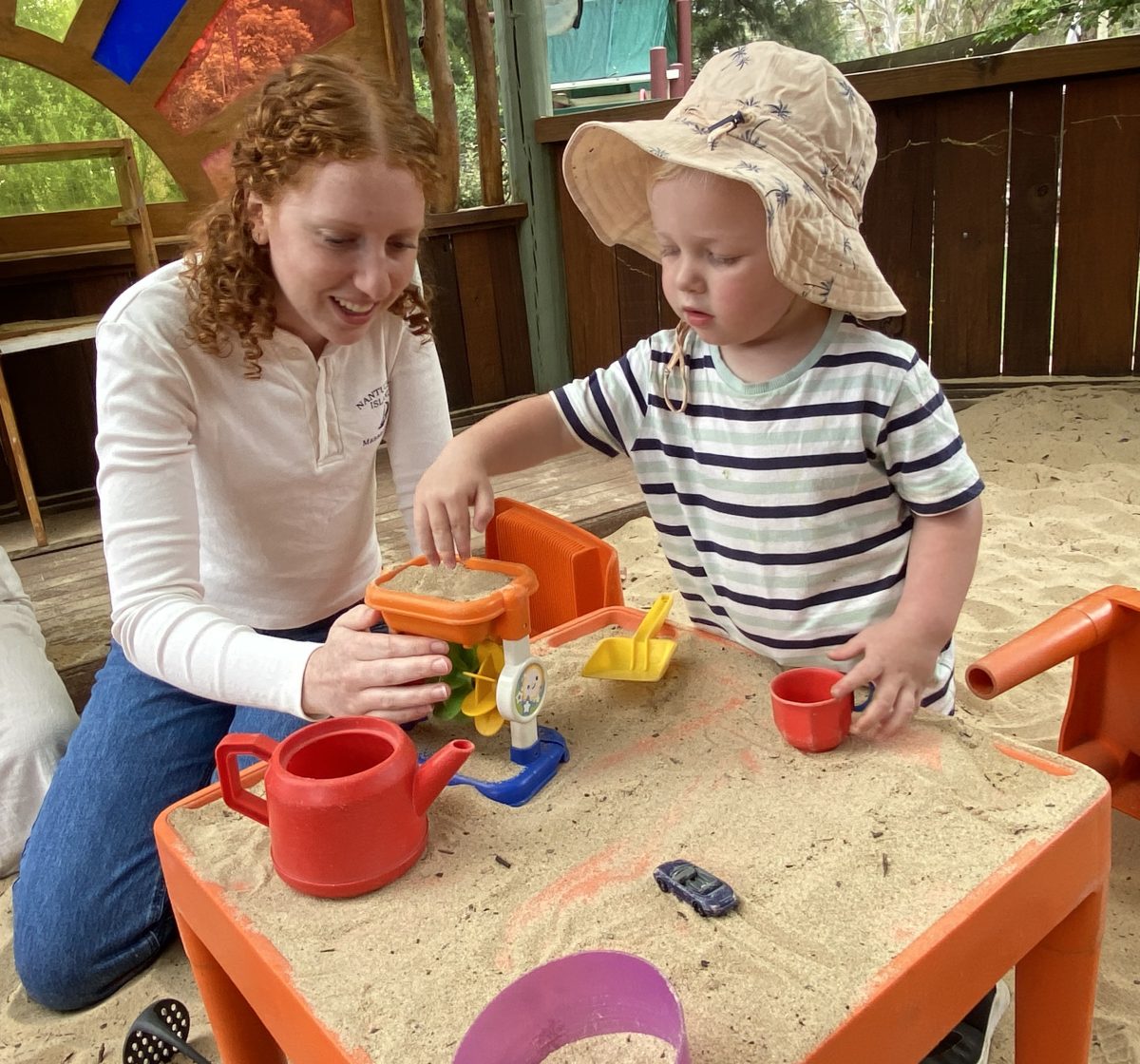 young woman with child at daycare centre