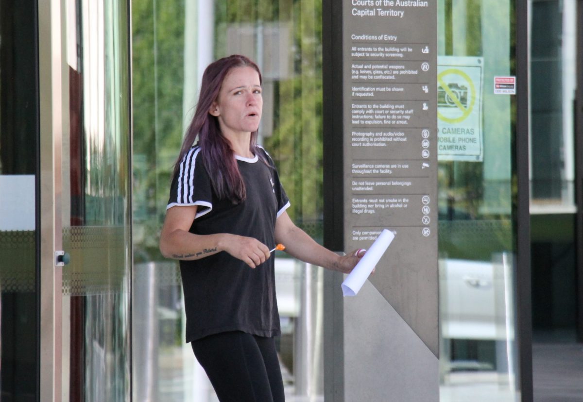 woman leaving court holding a lollipop