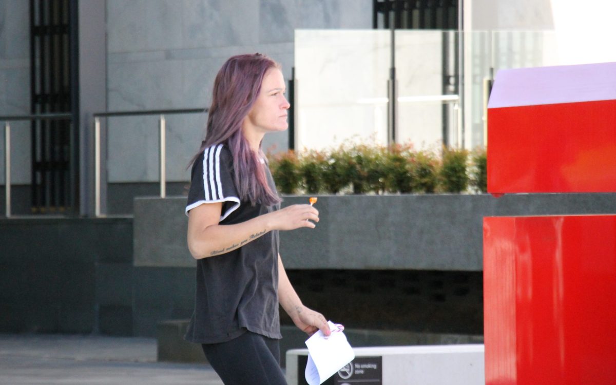 woman leaving court holding a lollipop 