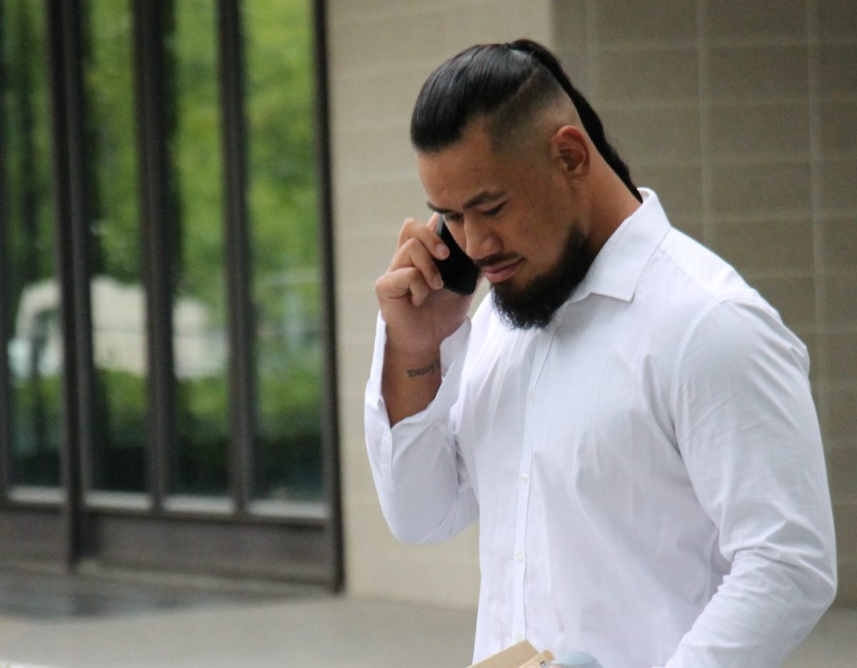 man on phone outside court