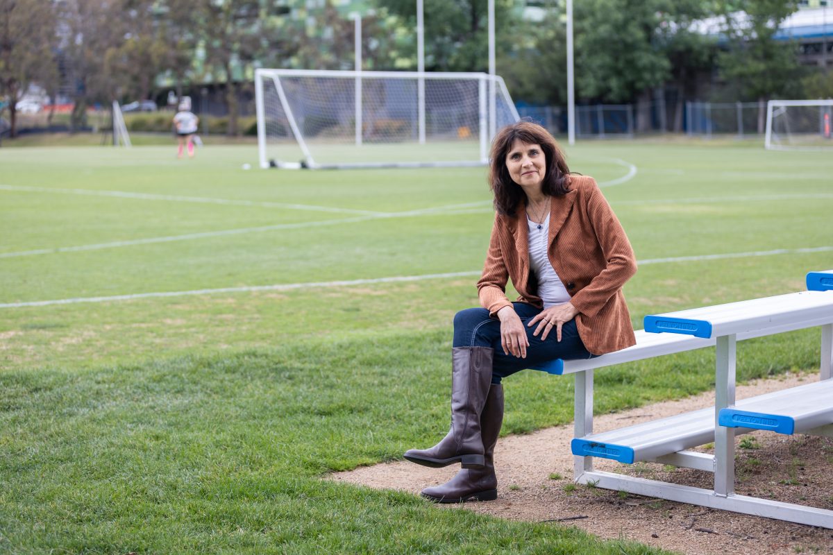 woman sitting on soccer field