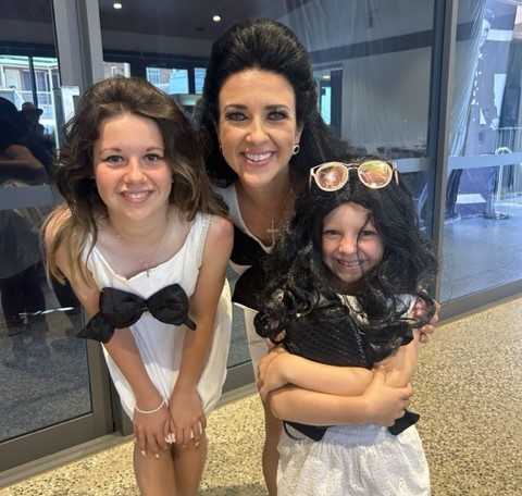 woman and two young girls dressed as Priscilla Presley