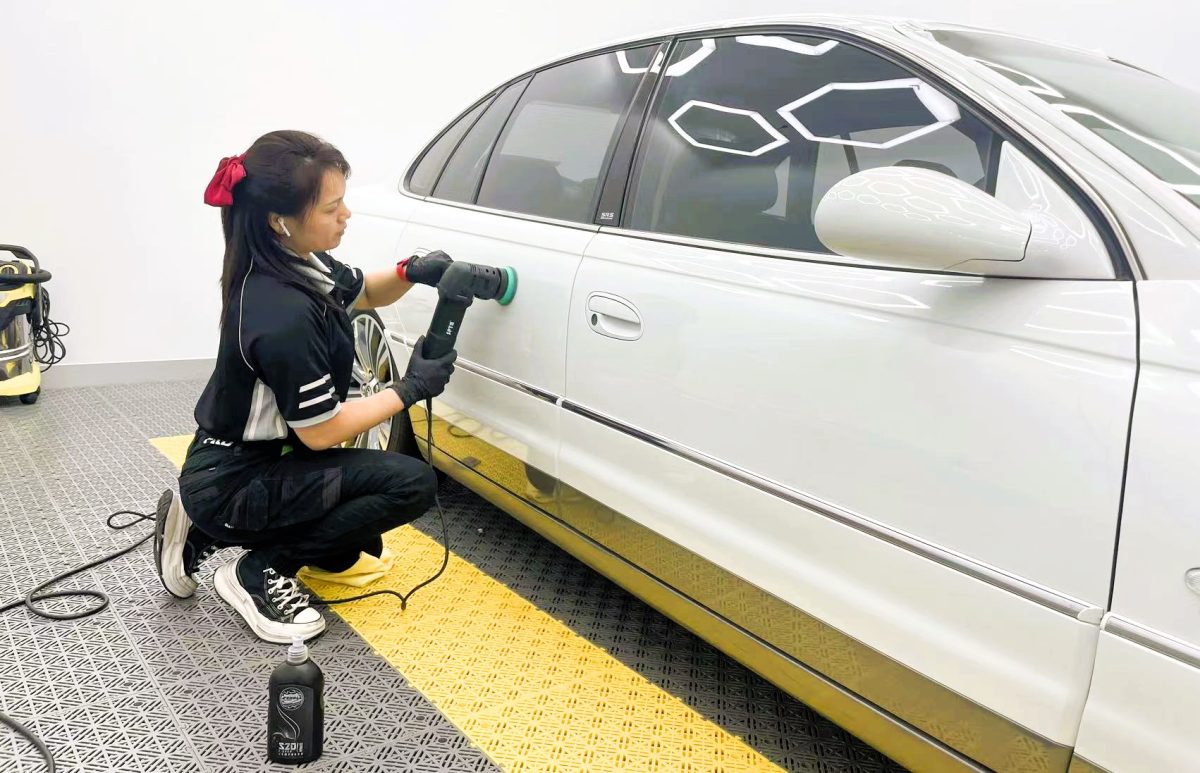 woman working on car film