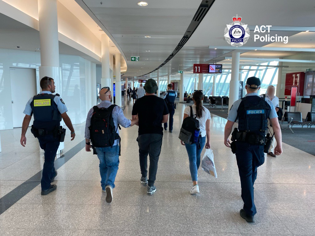 man under arrest with police in Canberra Airport