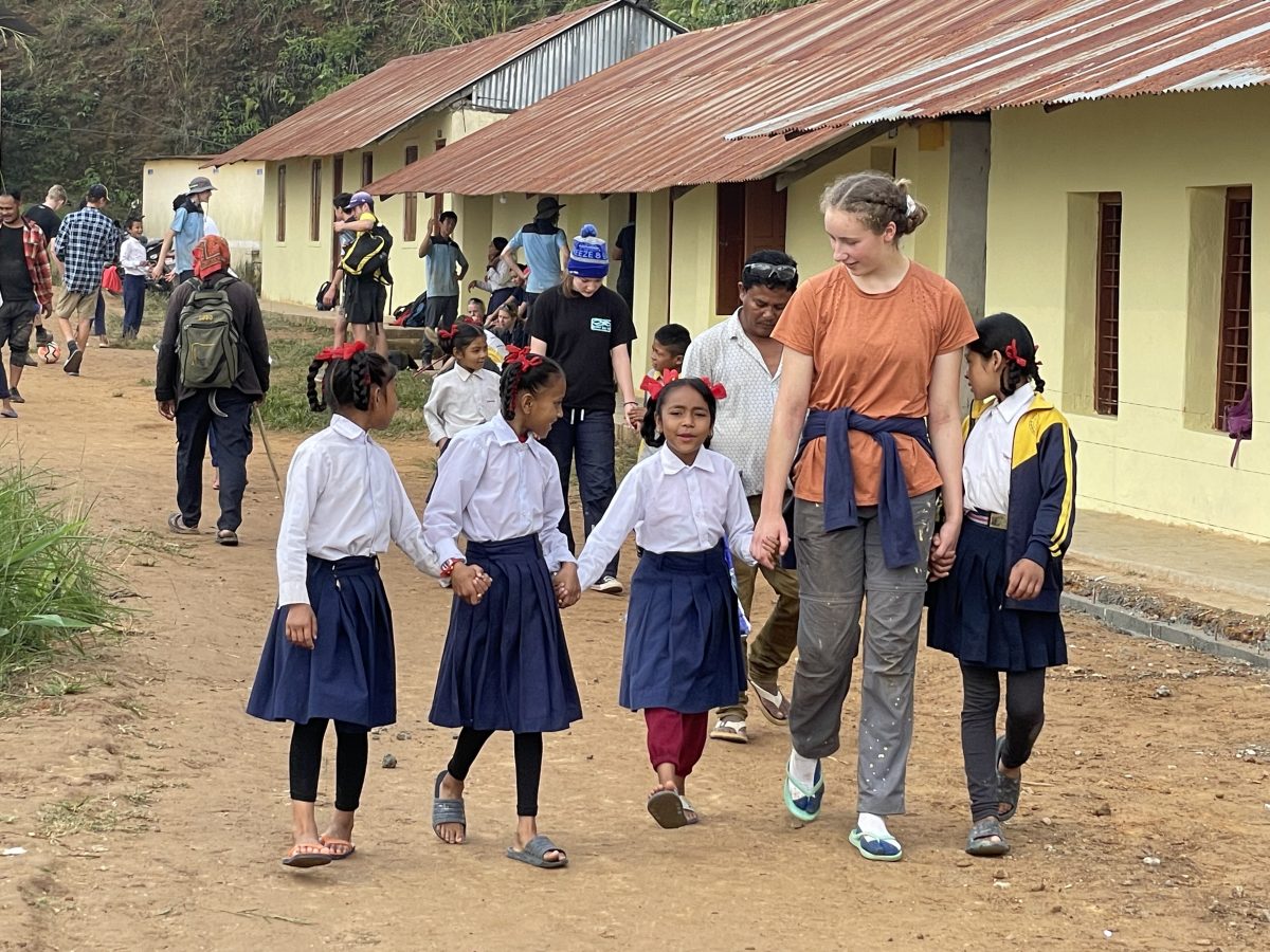 Canberrs teenager walking with childen in Nepal