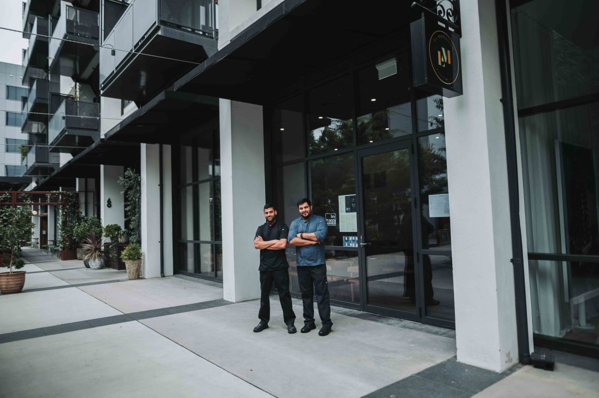 two man outside their restaurant