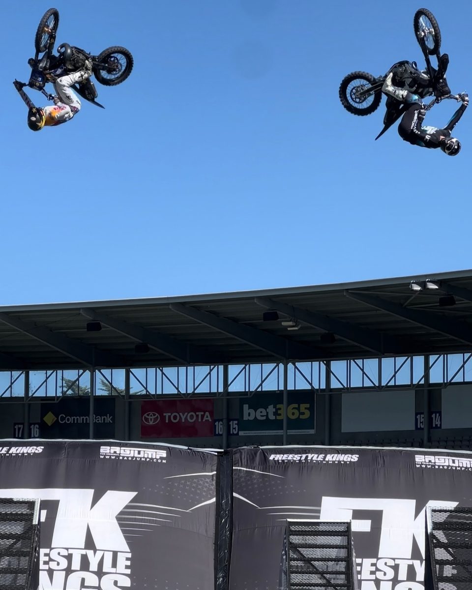 Two bike riders upside down in the air during a trick