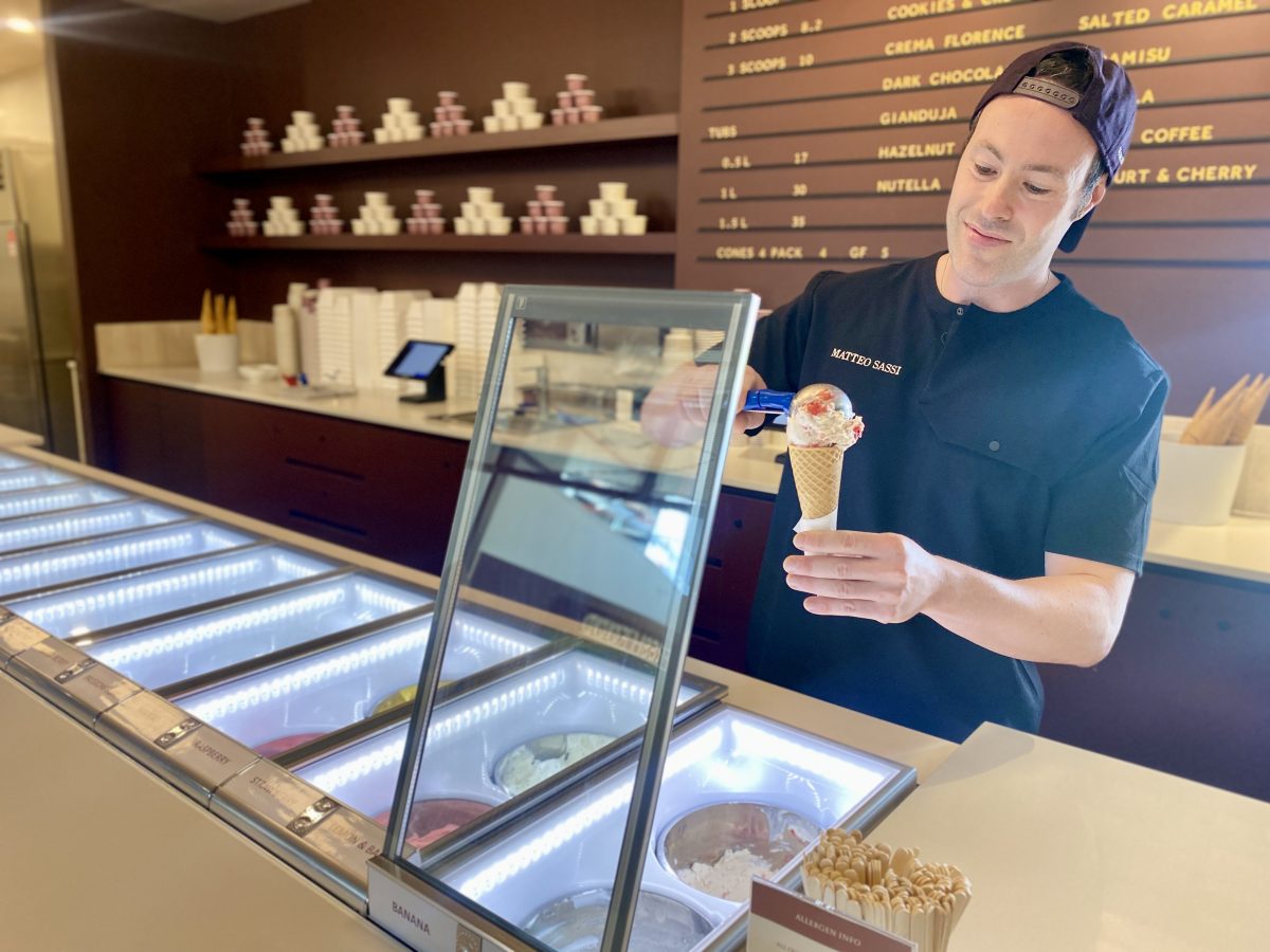 Matteo Sassi scoops ice cream into a cone.