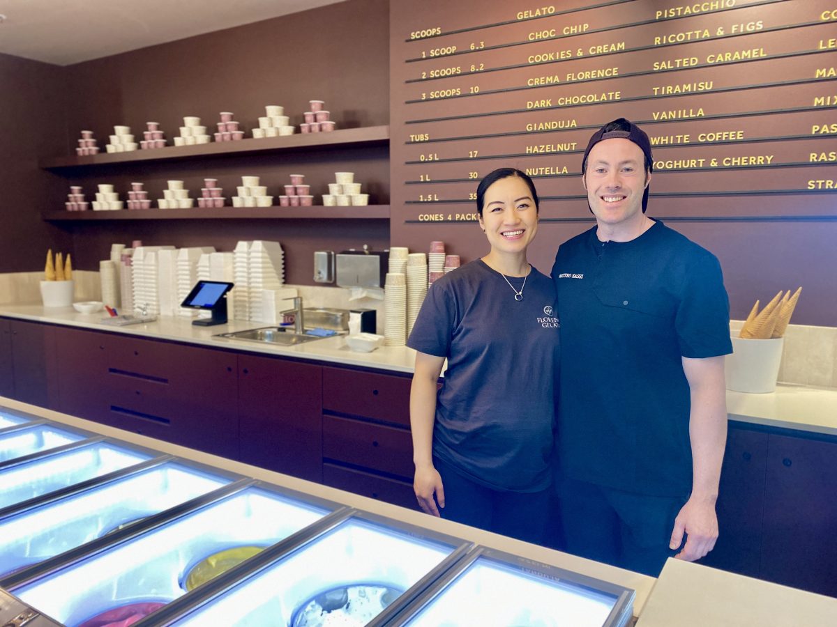 Matteo and Juliana smile in their gelato store.