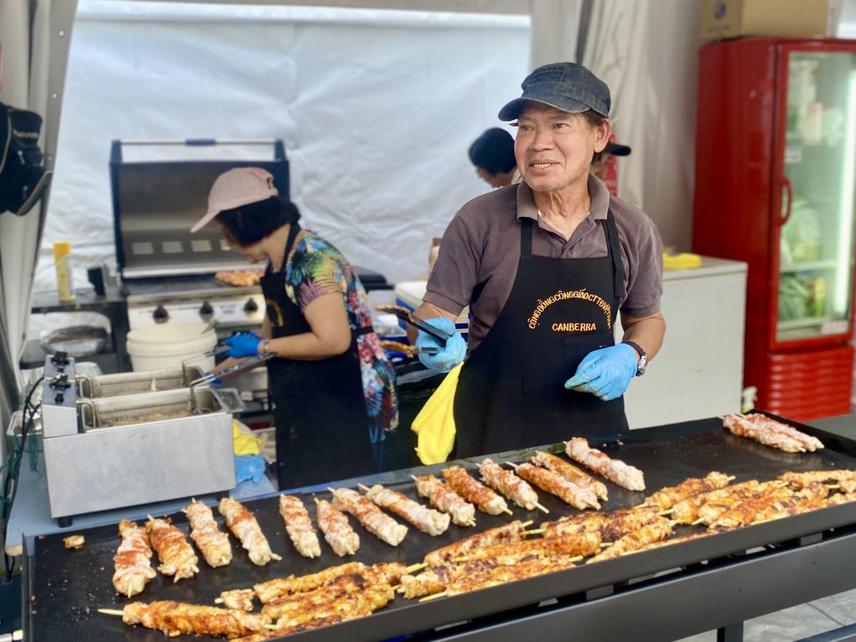 Man clicks tongs while grilling