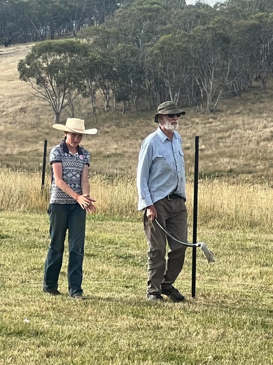 Girl and man wearing hats in padock